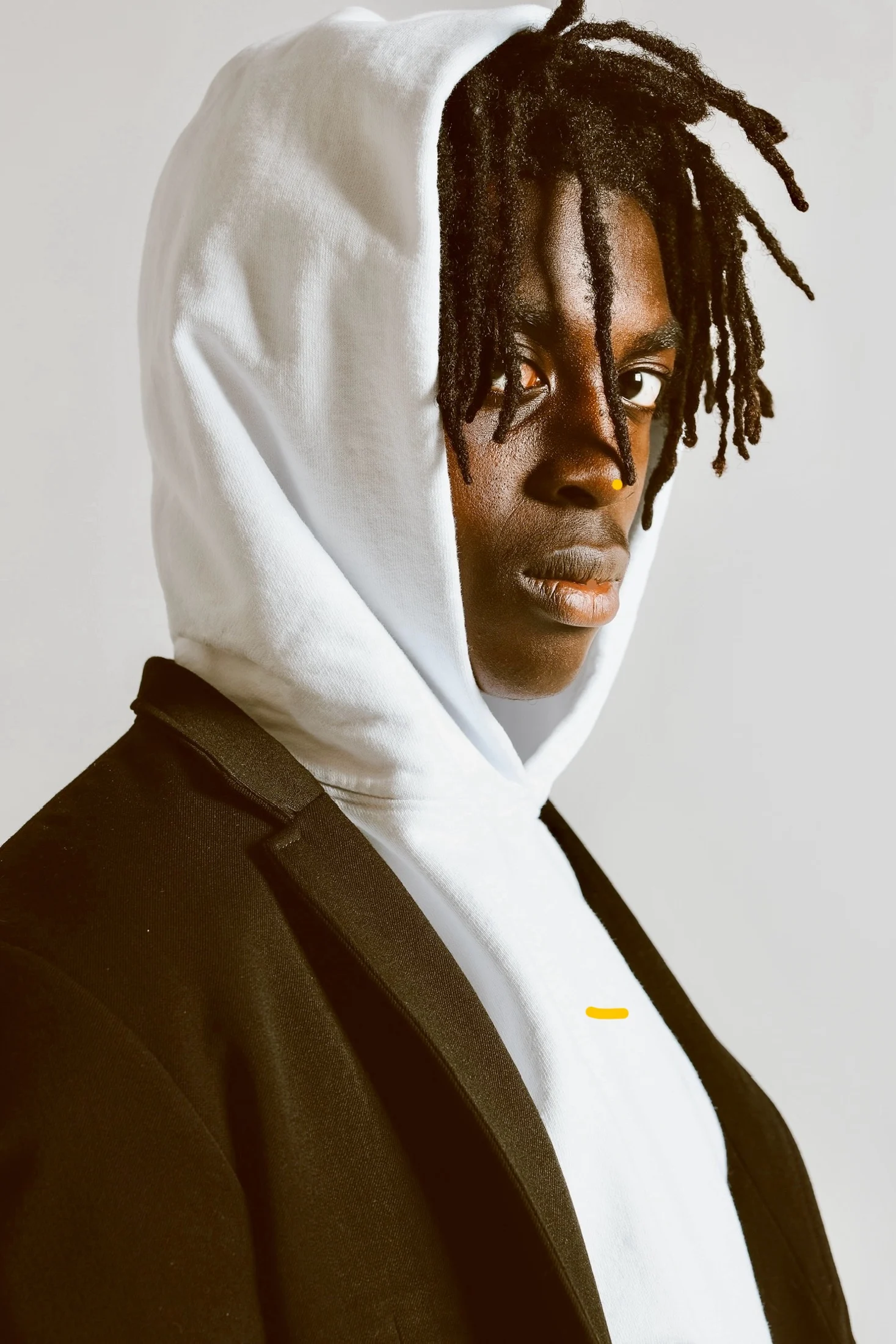 Justice wearing a white hoodie and dark jacket