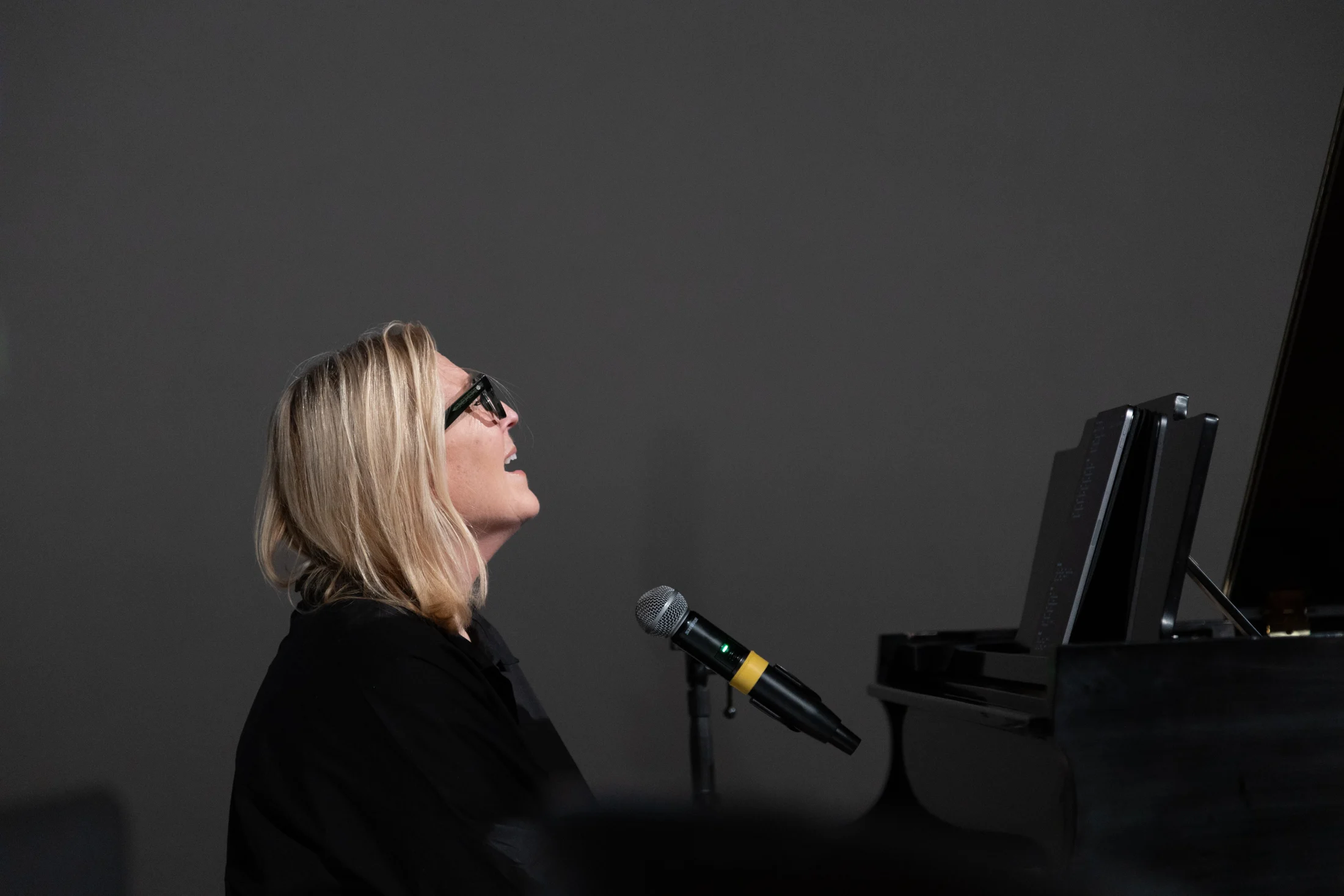 Rita Springer singing at the piano