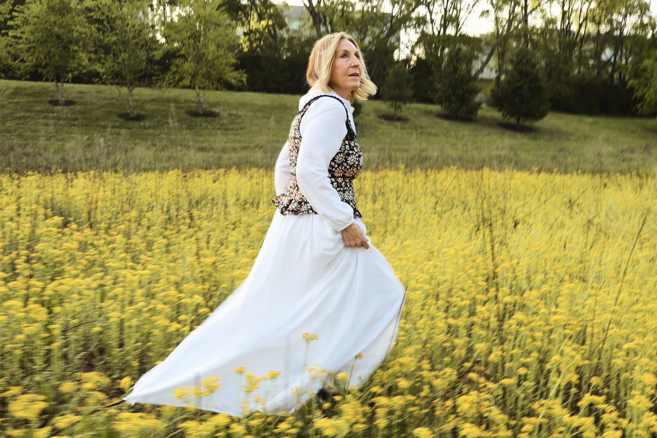 Rita walking through a sunlit meadow