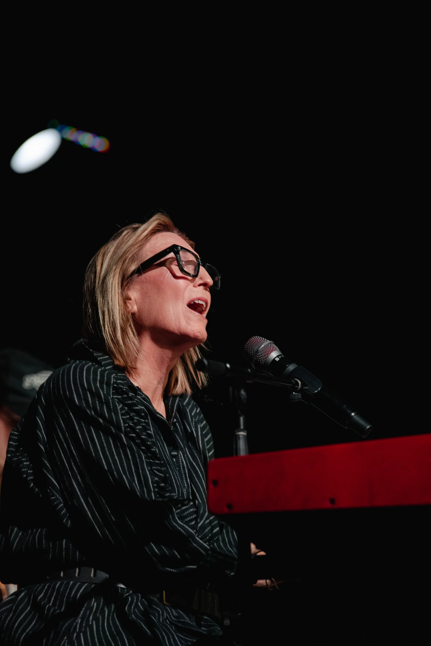 Rita singing and playing a keyboard